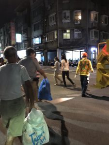 Men approaching a garbage truck.