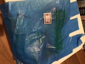 Plastic bag with writing on it.