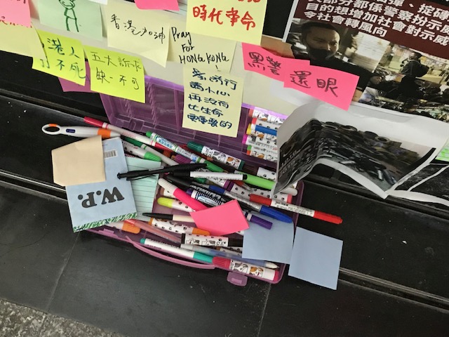 Containers of pens and markers.