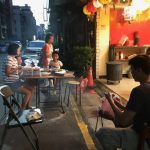 Family enjoying a street-side barbecue