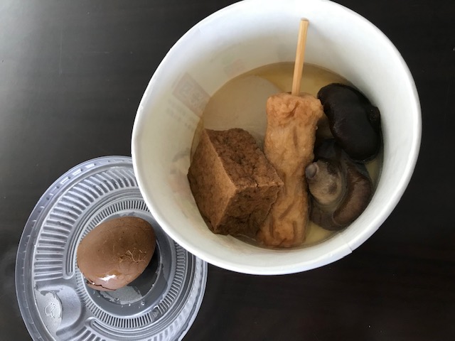 Bowl of food, including an item on a stick.