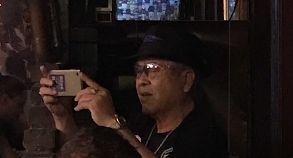 Club owner Tsai Hui-yang photographing the band.