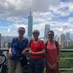 Jeanne Neumann, Shelley Rigger, and Annie Merrill in front of the Taipei skyline