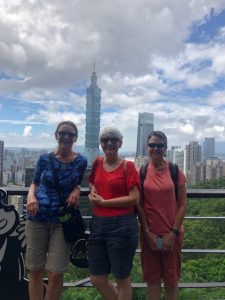 Jeanne Neumann, Shelley Rigger, and Annie Merrill in front of the Taipei skyline
