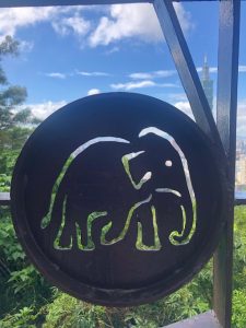 Circular placard with an elephant cut-out.