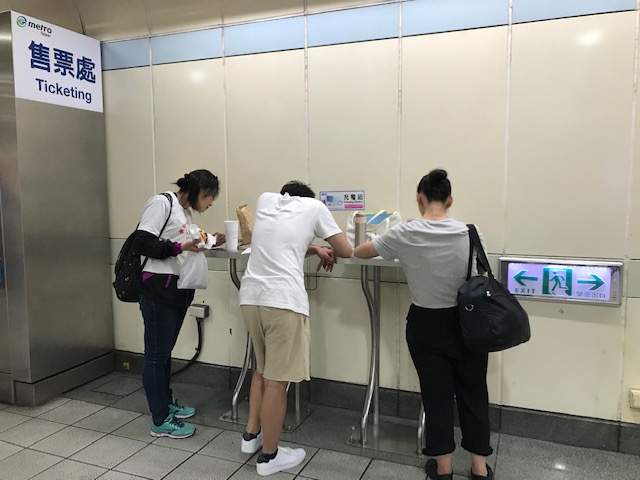 People charging phones in the subway