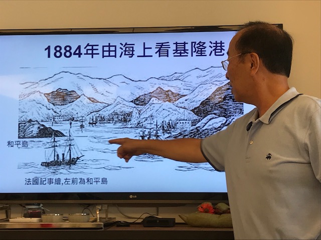 Captain Kuo pointing at an image of the harbor.
