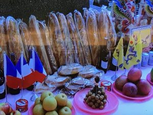 A table of offerings including baguettes and wine.
