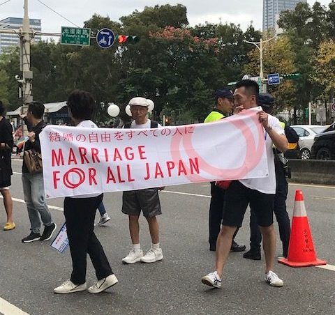 Men carrying a sign reading "Marriage for all Japan."
