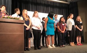 Young people on a stage.