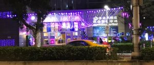 Building front with a canopy of purple lights.