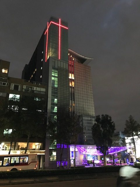 Church with huge cross in red lights on the roof.