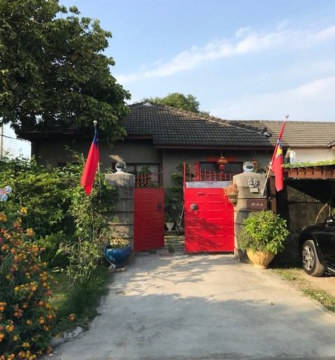 A house with two ROC flags on either side of the gate.