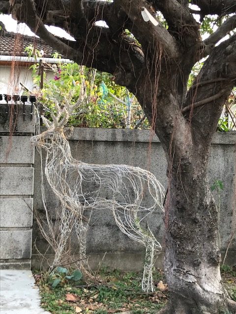 A life-sized deer sculpted in wire.