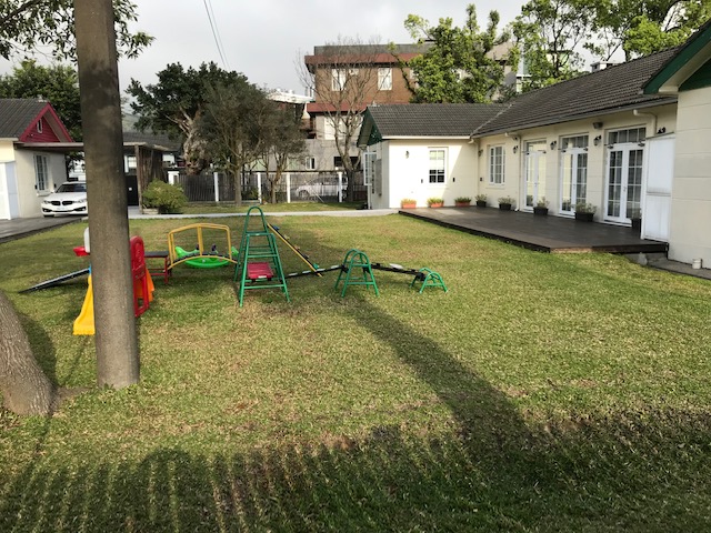 Grassy yard with play ground.